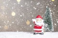 Miniature Christmas Santa cros and Tree on snow over blurred bokeh background,Decoration Image for Christmas Holiday and Happy New Royalty Free Stock Photo