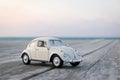 Miniature classic beautiful white car parked near the sea Royalty Free Stock Photo