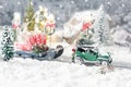 Miniature classic car carrying a christmas tree and gifts on snowy road in winter background Royalty Free Stock Photo