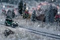 Miniature classic car carrying a christmas tree on snowy road in winter Royalty Free Stock Photo
