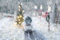 Miniature classic car carrying a christmas tree on on snowy road in winter Royalty Free Stock Photo