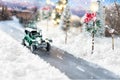 Miniature classic car carrying a christmas tree on winter magic background Royalty Free Stock Photo