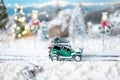 Miniature classic car carrying a christmas tree on winter Royalty Free Stock Photo