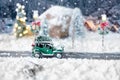 Miniature classic car carrying a christmas tree on winter Royalty Free Stock Photo