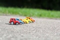 Miniature colorful cars standing in line on road sale concept