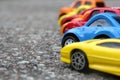 Miniature colorful cars standing in line on road sale concept