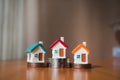 Miniature colorful house on stack coins