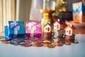 Miniature colorful house on stack coins