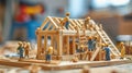 Miniature Workers Constructing Wooden House Model Royalty Free Stock Photo
