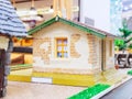Miniature decorative house with a window and a green roof