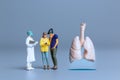 Miniature Doctors study and treat large human lungs, World Health Day concept