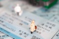 Miniature doll model standing on the train ticket