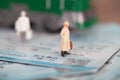 Miniature doll model standing on the train ticket