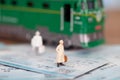 Miniature doll model standing on the train ticket