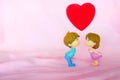 Miniature dolls of couple boy and girl kiss and have big red heart on above with pink background for Valentine`s Concept Royalty Free Stock Photo