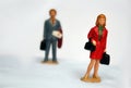 Miniature elegant woman and some man behind her, looking or follow the lady, stalking or sexual harassment concept, admirer, Royalty Free Stock Photo