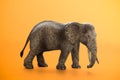 Miniature elephant animal toy on orange background Royalty Free Stock Photo
