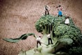 Miniature farmers crew harvesting broccoli crowns Royalty Free Stock Photo