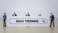 Miniature figure businessmen standing with white board and 2024 trends wording for business marketing searching and planning