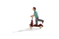 Miniature figure of a child on a scooter Royalty Free Stock Photo