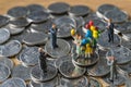 Miniature figure family holding balloon standing on stack of coins and others clapping as financial business or happy retirement Royalty Free Stock Photo