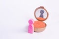 A miniature figure of a man looks in the mirror and sees his hatching in another gender. The concept of gender identity.