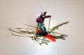 Miniature figure of a Man skiing on winter snow