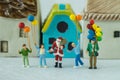 Miniature figure Santa claus standing with happy family holding Royalty Free Stock Photo