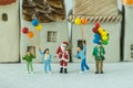 Miniature figure Santa claus standing with happy family holding Royalty Free Stock Photo