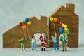 Miniature figure Santa claus standing with happy family people h