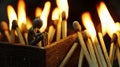 Miniature figure sitting in a matchstick box surrounded by fire Royalty Free Stock Photo