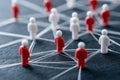 Miniature figures connected by threads show communication, work delegation. Networked team members share experience, mentor.