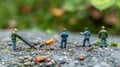 Miniature Workers Installing a Large Screw on Ground Royalty Free Stock Photo