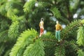 Miniature figures talking on the tree Royalty Free Stock Photo