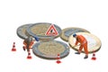 Miniature figures working on a heap of Euro coins. Royalty Free Stock Photo