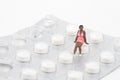 Miniature of a black girl on a pills blister