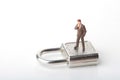 Miniature figurine of a businessman on a huge padlock Royalty Free Stock Photo