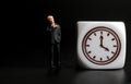 Miniature figurine of a businessman looking his watch Royalty Free Stock Photo