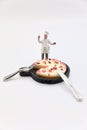 miniature figurine of a chef with a pizza