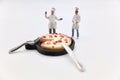 miniature figurine of a chef with a pizza