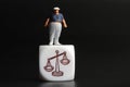 Miniature figurine of a fat man standing on the balance icon