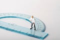 Miniature figurine of a geometry teacher on a protractor Royalty Free Stock Photo
