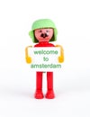 miniature figurine of a man hodling paper with text welcome to amsterdam