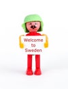 miniature figurine of a man holding paper with text welcome to sweden