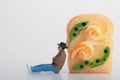 Miniature figurine of a man leaning on a giant sandwich Royalty Free Stock Photo