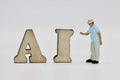 miniature figurine of people with artificial intelligence abbreviation Royalty Free Stock Photo