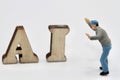 miniature figurine of people with artificial intelligence abbreviation Royalty Free Stock Photo