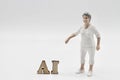miniature figurine of people with artificial intelligence abbreviation Royalty Free Stock Photo