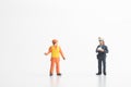 Miniature figurine of a policewoman making a fine to a worker