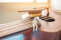 Miniature figurines Businessman sitting on ukulele with Graduation cap. Ukuleles is member lute family instruments with nylon Royalty Free Stock Photo